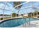 Inviting kidney-shaped pool with screened enclosure at 22259 Priscilla Ave, Port Charlotte, FL 33954