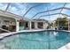 Inviting pool area with covered patio and seating at 22259 Priscilla Ave, Port Charlotte, FL 33954