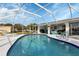 Inviting kidney-shaped pool with screened enclosure at 22259 Priscilla Ave, Port Charlotte, FL 33954