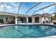 Inviting kidney-shaped pool with screened enclosure at 22259 Priscilla Ave, Port Charlotte, FL 33954