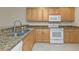 Kitchen with wood cabinets, granite countertops, and stainless steel appliances at 240 W End Dr # 412, Punta Gorda, FL 33950