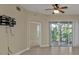 Living room with tile floors, sliding glass doors, and a ceiling fan at 240 W End Dr # 412, Punta Gorda, FL 33950