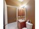 Bathroom with toilet, sink, and a wooden cabinet at 24067 Park Place S Dr # 71, Port Charlotte, FL 33980