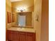 Bathroom with wood vanity, sink, and large mirror at 24067 Park Place S Dr # 71, Punta Gorda, FL 33980