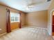 Carpeted bedroom with ceiling fan and window with curtains at 24067 Park Place S Dr # 71, Punta Gorda, FL 33980