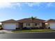 Two-unit building exterior with two-car garages and palm trees at 24067 Park Place S Dr # 71, Punta Gorda, FL 33980