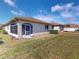 Tan house exterior with a screened porch and yard at 24067 Park Place S Dr # 71, Punta Gorda, FL 33980