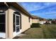 Tan house exterior with a screened porch and landscaping at 24067 Park Place S Dr # 71, Port Charlotte, FL 33980