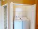 Well-lit laundry room with washer, dryer, and shelving at 24067 Park Place S Dr # 71, Punta Gorda, FL 33980