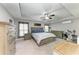 Spacious bedroom with large bed, dresser, and ceiling fan at 2467 Odessa Ln, Punta Gorda, FL 33983