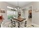 Bright dining area with farmhouse table and chairs, view into kitchen at 2467 Odessa Ln, Punta Gorda, FL 33983