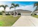 House exterior showcasing landscaping, a driveway, and a two-car garage at 2467 Odessa Ln, Punta Gorda, FL 33983