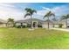 Single-story house with palm trees, well-maintained landscaping, and a two-car garage at 2467 Odessa Ln, Punta Gorda, FL 33983