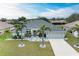 Single-story house with a gray roof, palm trees, and a well-manicured lawn at 2467 Odessa Ln, Punta Gorda, FL 33983