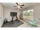 Bright home gym with exercise bike, TV, and rocking chair at 2467 Odessa Ln, Punta Gorda, FL 33983