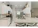 White kitchen with granite countertops and subway tile backsplash at 2467 Odessa Ln, Punta Gorda, FL 33983