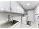 Laundry room with white cabinets, stainless steel sink, and washer/dryer at 2467 Odessa Ln, Punta Gorda, FL 33983