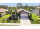 One-story house, gray siding, two-car garage, and palm trees at 2529 Sherman Oak Dr, North Port, FL 34289