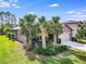 One-story home with gray siding, two-car garage, and palm trees at 2529 Sherman Oak Dr, North Port, FL 34289