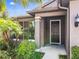 Dark brown front door with brown shutters and landscaping at 2529 Sherman Oak Dr, North Port, FL 34289