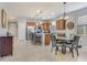 Open concept kitchen and dining area with wood cabinets and tile flooring at 2529 Sherman Oak Dr, North Port, FL 34289