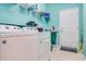 Laundry room with washer, dryer, and storage shelves at 2529 Sherman Oak Dr, North Port, FL 34289