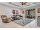 Relaxing living room featuring comfy recliner and large area rug at 2529 Sherman Oak Dr, North Port, FL 34289