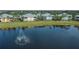 Community overview featuring lake, fountain, and residential buildings at 25533 Heritage Lake Blvd # 19, Punta Gorda, FL 33983