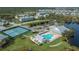 Aerial view of community with pool, tennis courts, and clubhouse at 25533 Heritage Lake Blvd # 19, Punta Gorda, FL 33983