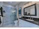 Updated bathroom with a frameless glass shower, granite countertop, and modern fixtures at 25533 Heritage Lake Blvd # 19, Punta Gorda, FL 33983