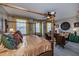 Spacious bedroom with a four-poster bed and sitting area at 25533 Heritage Lake Blvd # 19, Punta Gorda, FL 33983