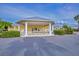 Community clubhouse with covered entryway and lush landscaping at 25533 Heritage Lake Blvd # 19, Punta Gorda, FL 33983