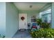 Inviting front porch with white door and festive holiday decor at 25533 Heritage Lake Blvd # 19, Punta Gorda, FL 33983