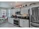 Modern kitchen with white cabinets, stainless steel appliances and granite counters at 25533 Heritage Lake Blvd # 19, Punta Gorda, FL 33983