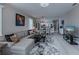 Open living room with light gray sectional sofa and view of kitchen at 25533 Heritage Lake Blvd # 19, Punta Gorda, FL 33983