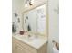 Bathroom boasts a vanity with a large mirror and stylish decor at 27251 Adams St # 212, Punta Gorda, FL 33983