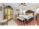 Spacious main bedroom with a king-size bed and decorative armoire at 27251 Adams St # 212, Punta Gorda, FL 33983