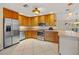 Kitchen with wood cabinets and stainless steel appliances at 287 Fortaleza St, Punta Gorda, FL 33983