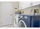 Laundry room with washer, dryer, and ample storage at 287 Fortaleza St, Punta Gorda, FL 33983