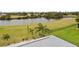 Aerial view of property with backyard, canal, and lush landscape at 303 San Cristobal Ave, Punta Gorda, FL 33983