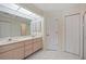 Double vanity bathroom with light peach cabinets and tile flooring at 303 San Cristobal Ave, Punta Gorda, FL 33983