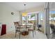 Bright breakfast nook features a glass table and chairs, offering water views at 303 San Cristobal Ave, Punta Gorda, FL 33983