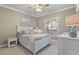 Bedroom with white bed, ceiling fan, and coastal decor at 3329 Purple Martin Dr # 121, Punta Gorda, FL 33950