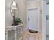 Entryway with console table, mirror, and white door at 3329 Purple Martin Dr # 121, Punta Gorda, FL 33950