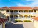 Two-story building with balconies, terracotta roofs, and a courtyard at 3329 Purple Martin Dr # 121, Punta Gorda, FL 33950