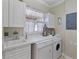 Laundry room with white cabinets, washer, and dryer at 3329 Purple Martin Dr # 121, Punta Gorda, FL 33950