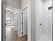 White tiled shower and hallway to bedrooms at 3733 Basket St, North Port, FL 34288