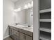 Double vanity bathroom with a large mirror and shelving at 3733 Basket St, North Port, FL 34288