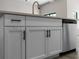 Kitchen island with white shaker cabinets and black hardware at 3733 Basket St, North Port, FL 34288