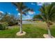 Landscaped backyard with golf course view and palm trees at 3845 Bal Harbor Blvd, Punta Gorda, FL 33950